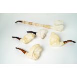 Five meerschaum style pipes in sizes four carved as turbanned and bearded men,