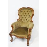 A Victorian mahogany show frame armchair with button back on carved cabriole legs,