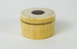 A nineteenth century ivory box, the screw top inset with a rosewood disk,