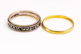 A hallmarked 22ct gold 2mm wedding ring; A marcasite set full eternity ring. Both size N.