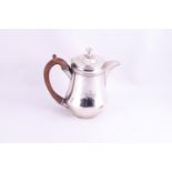 A small silver coffee pot,