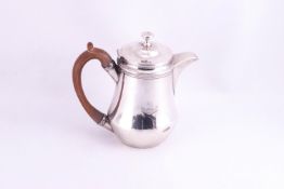 A small silver coffee pot,