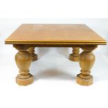 A large oak drawleaf dining table on baluster legs on octagonal block feet
