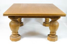 A large oak drawleaf dining table on baluster legs on octagonal block feet