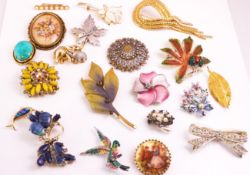 A collection of twenty costume brooches of variable designs.