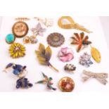 A collection of twenty costume brooches of variable designs.