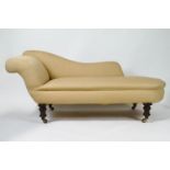 A chaise longue, on mahogany turned tapering legs with brass and casters,