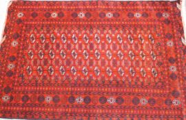 A hand knotted organic red dyed Bukhara rug,