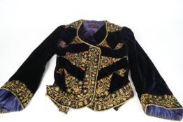 A collection of vintage clothing and textiles to include: an Edwardian brown velvet lady's jacket,