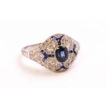 A white metal dress ring. Principally set with and oval faceted cut sapphire.