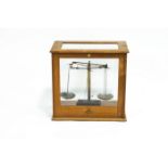 A set of laboratory scales by Becker's Sons, Rotterdam, in a case by Harris of B'ham,