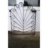 A wrought iron gate in a contrived sunburst design,