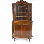 A mahogany Dutch style display cabinet with one glazed door above a candleslide