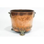 A copper coal bucket, applied with copper rivets, with cast leafy brass handles and paw feet,