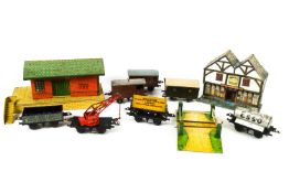 A Triang electric model railway, to include a station, crane, wagons, trains and track,