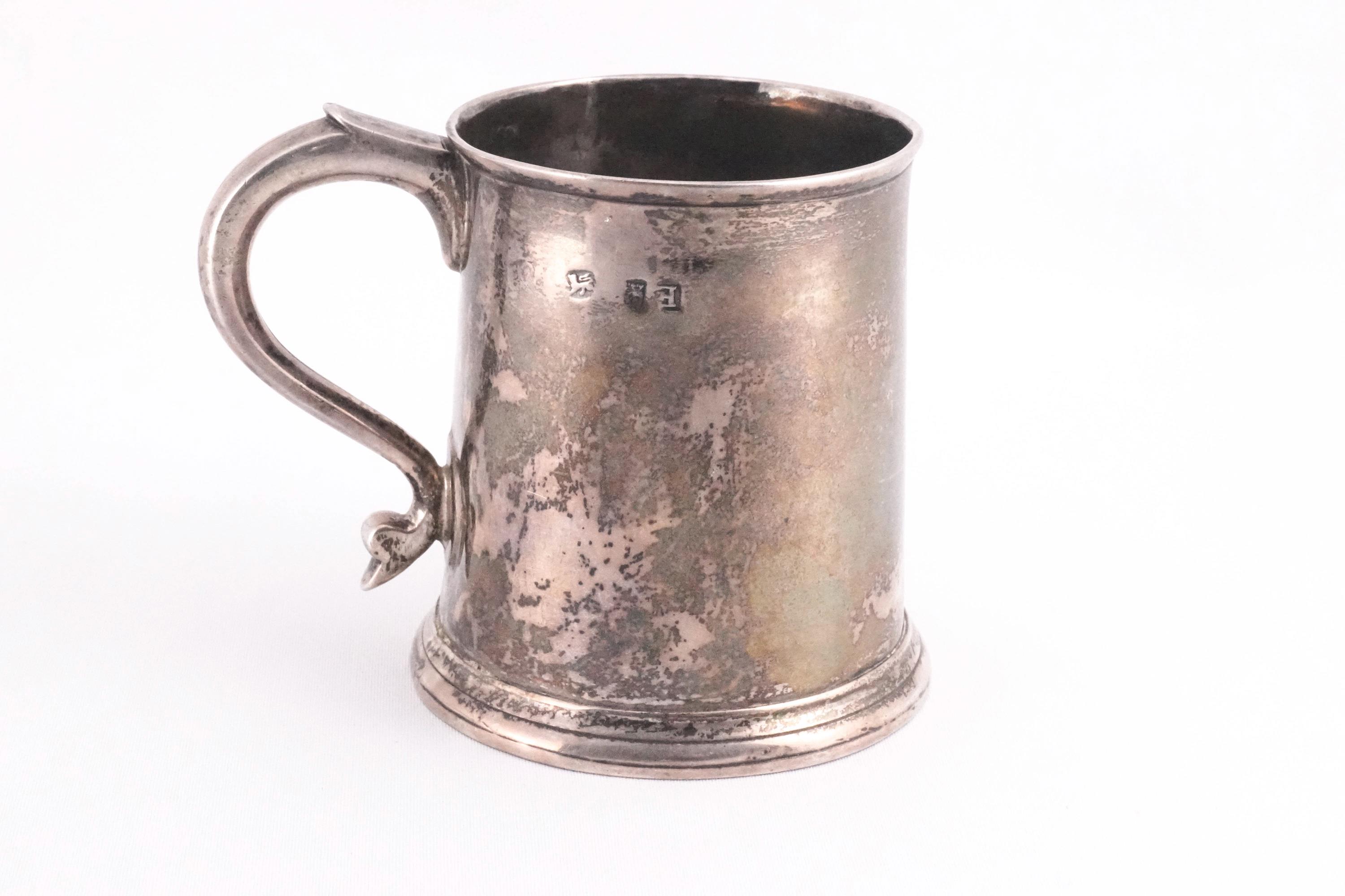 A small silver plain mug, of tapered round form,