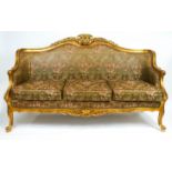 A carved giltwood and gesso Louis XV style three seater framed sofa,