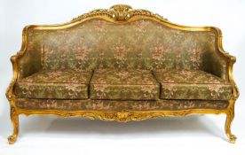 A carved giltwood and gesso Louis XV style three seater framed sofa,