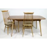 An Ercol beech and elm extending rectangular table with two leaves and table protector,