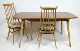 An Ercol beech and elm extending rectangular table with two leaves and table protector,