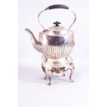 A silver spirit kettle of the usual semi-fluted oval form, on a cabriole leg burner stand,