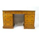 A Victorian oak pedestal desk with leather inset top above three drawers,