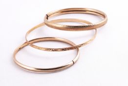 A collection of three yellow gold hollow bangles. Each hallmarked 9ct gold.