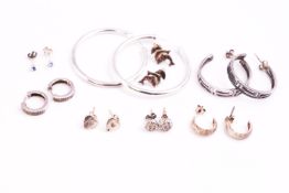 A collection of eight pairs of earrings of variable designs. Some are marked for sterling silver.