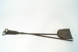 Two wrought iron fireside tools, designed by Ernest Gimson and probably designed by Alfred Bucknell,