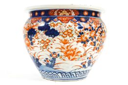 A large 19th century porcelain imari planter decorated in the imari palette with a pheasant