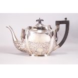 A silver teapot, of shaped oval form,