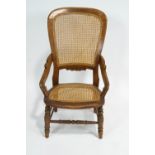 A Victorian cane armchair, stamped T H to reverse,