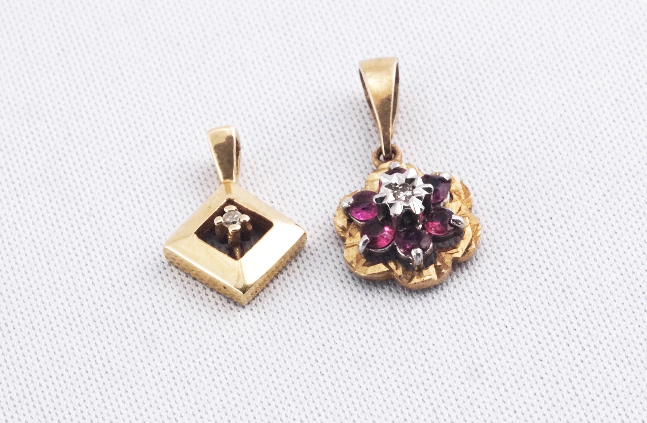 A hallmarked 9ct gold ruby and diamond flower pendant;