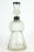 A silver mounted glass thistle shaped decanter and stopper, with panel and diamond cutting,