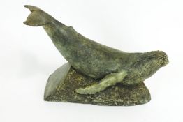 A Studio pottery simulated bronze model of a whale a crest waves,