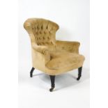 A Victorian armchair with shaped buttonback on square tapering fluted ebonised legs,