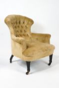 A Victorian armchair with shaped buttonback on square tapering fluted ebonised legs,