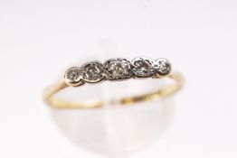 A yellow and white metal half hoop ring. Set with five graduated old cut diamonds.