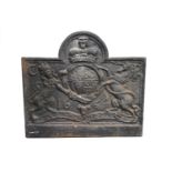 A cast iron fire back, cast with the Crowned Royal Arms, of arched rectangular form,