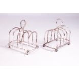 A pair of silver miniature form plain round arch toast racks with loop handles, raised on ball feet,