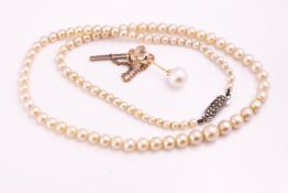 A tie pin set with an 8mm white cultured pearl together with a single strand of simulated pearls