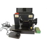 A rigid cased Singer 221K sewing machine,