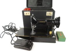 A rigid cased Singer 221K sewing machine,