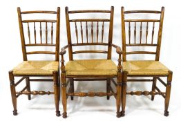 A set of six oak dining chairs each with turned spindle backs,