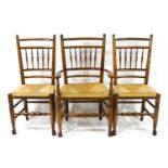 A set of six oak dining chairs each with turned spindle backs,