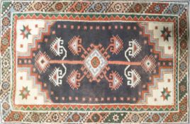 A Turkish rug with central medallion on a brown field within two borders