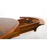 A late 20th/early 21st century oval walnut desk by Touchwood, with central flared support,