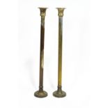 A pair of silvered brass ecclesiastical floor candlesticks, or plain columnar form,