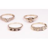 A collection of four dress rings to include: An illusion set fancy diamond band;