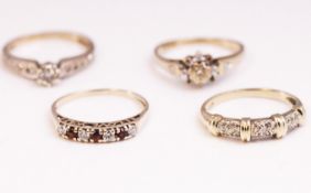 A collection of four dress rings to include: An illusion set fancy diamond band;